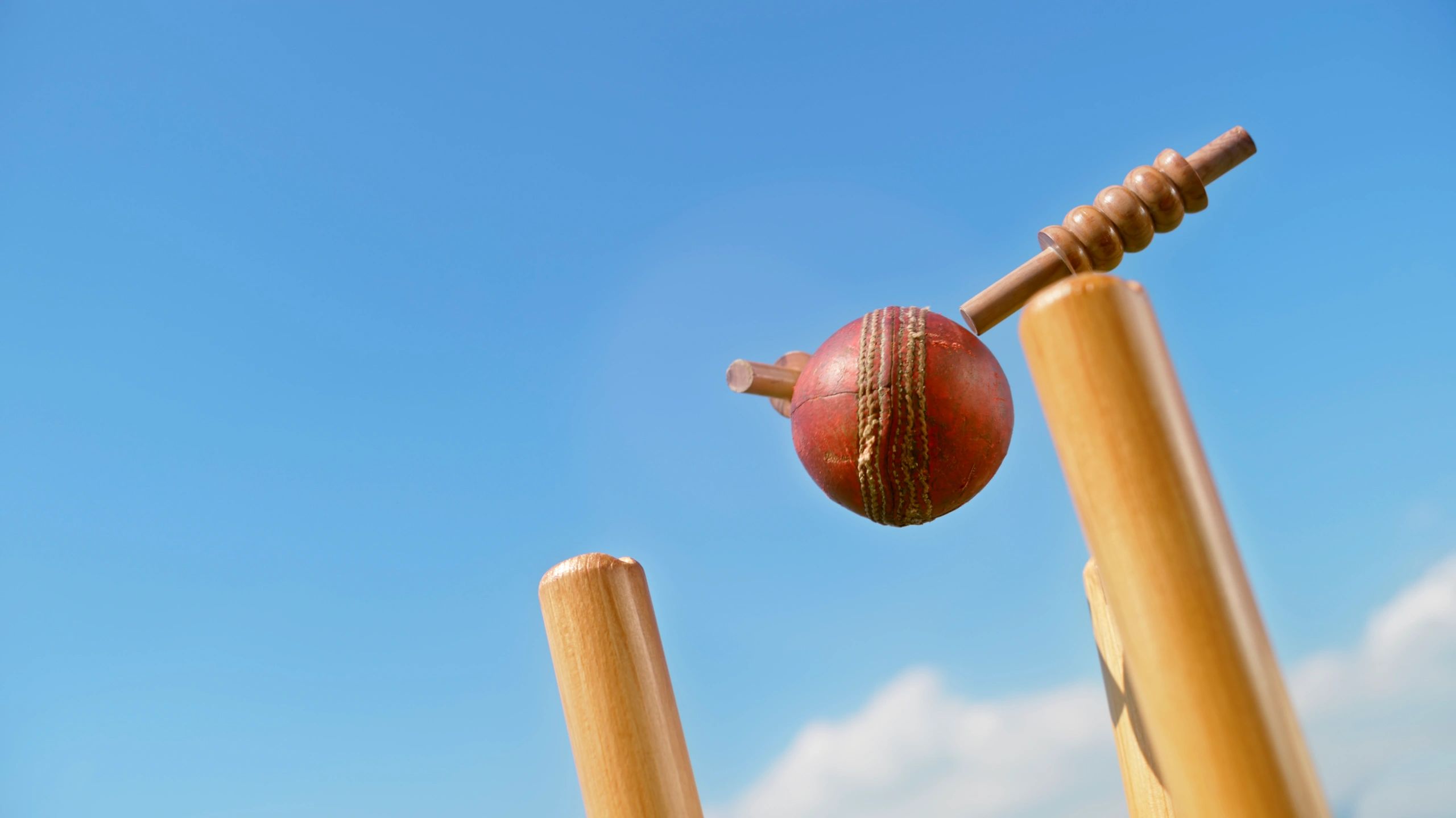 Cricket ball hitting the stumps