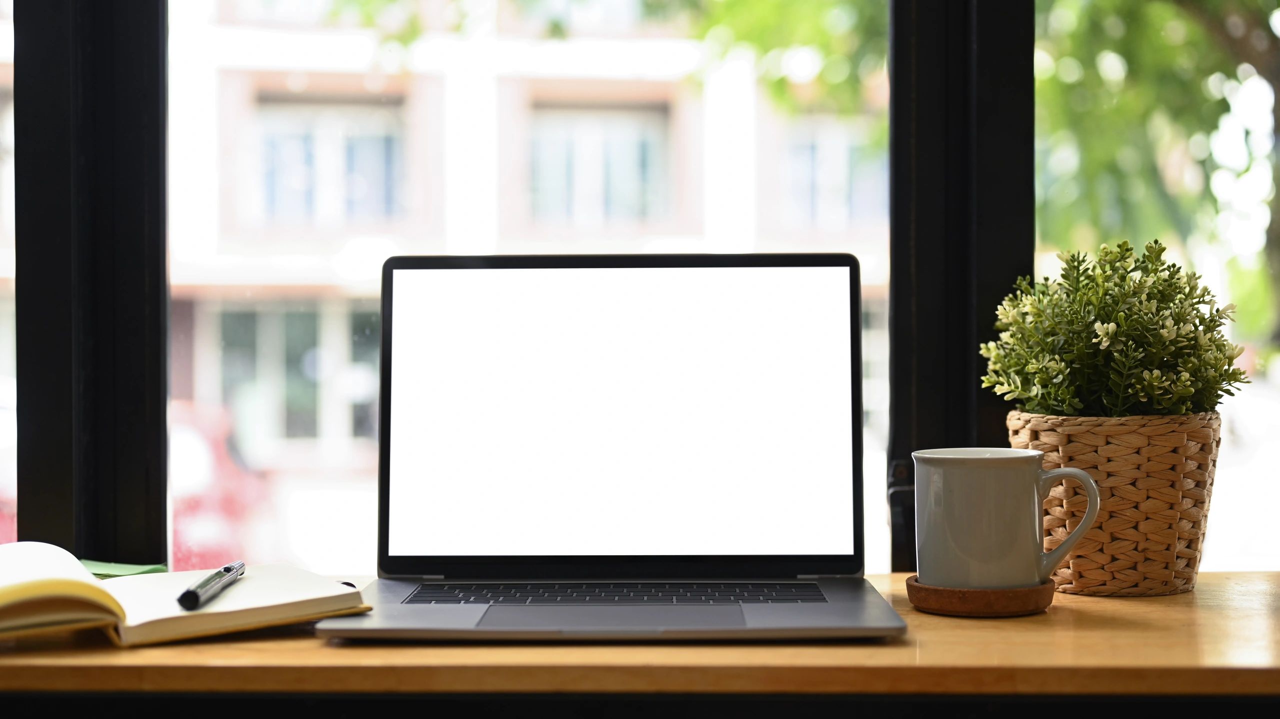 Laptop and notebook on a clean desk representing digital publishing