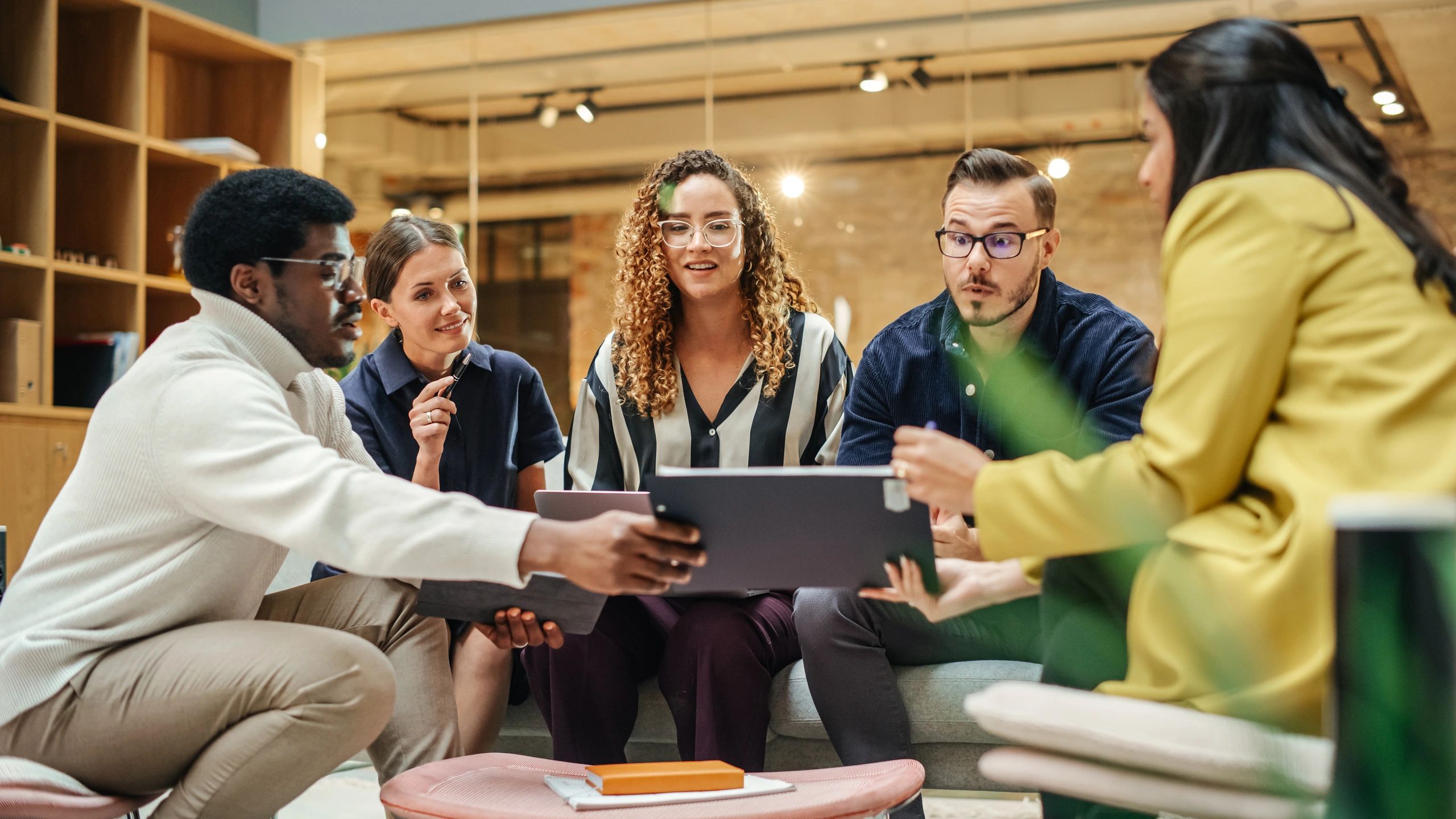 Editorial team collaborating in a modern newsroom