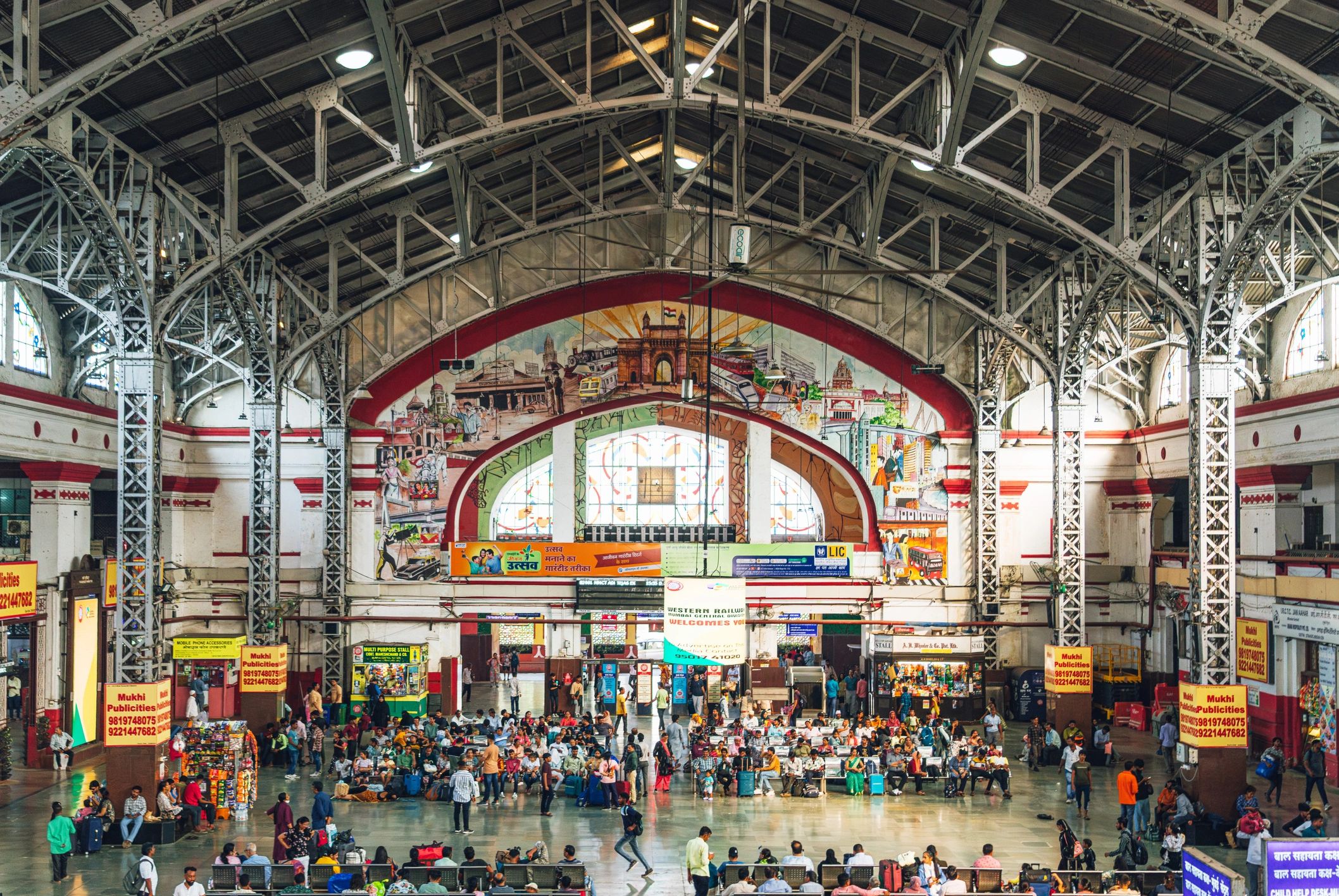 Busy Mumbai railway station interior with commuters